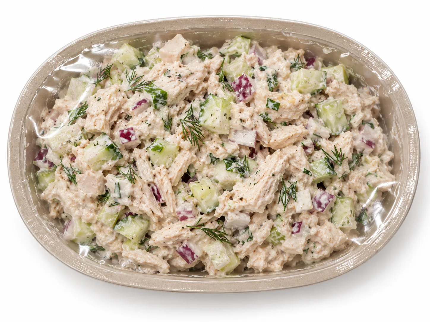 Creamy chicken salad with cucumber, red onion, and dill in an oval sealed tray